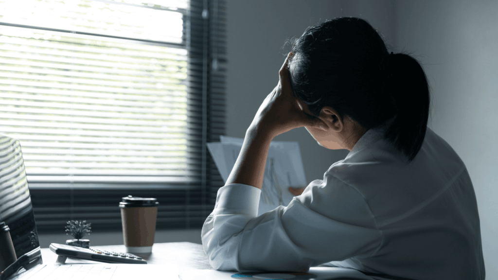 Person experiencing mental health challenges while working, illustrating why many need to learn how to apply for SSDI for mental health benefits