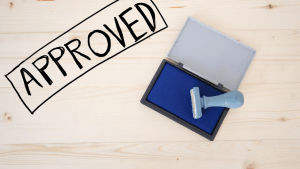 SSDI approval and denial rates represented by approved rubber stamp on ink pad
