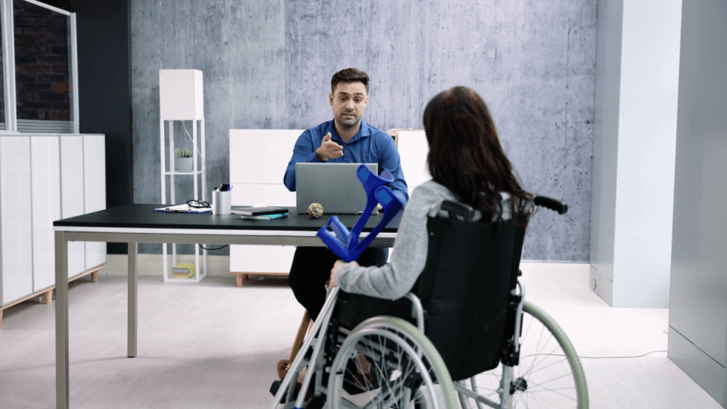Changes in SSDI appeal outcomes discussion between disability attorney and wheelchair user reviewing case file
