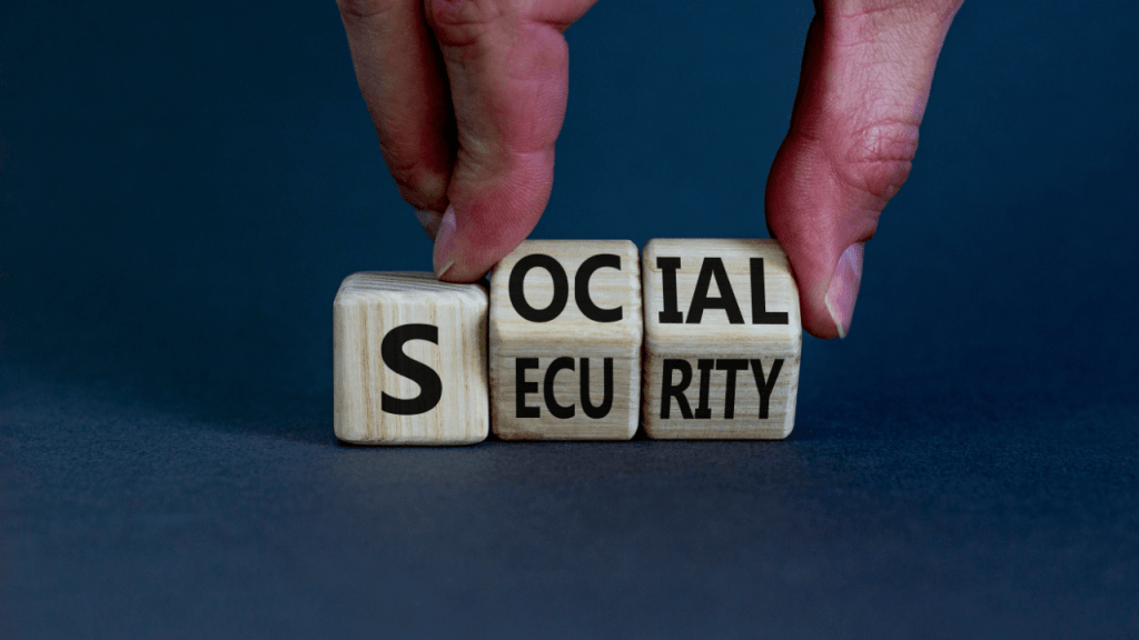 SSDI changes and updates concept with hands arranging Social Security wooden letter blocks on blue surface