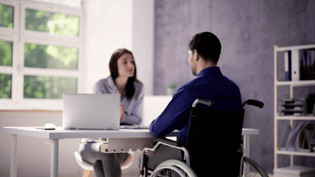 SSDI processing times and backlogs consultation with disability applicant in wheelchair meeting with representative