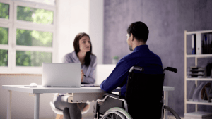 SSDI processing times and backlogs consultation with disability applicant in wheelchair meeting with representative