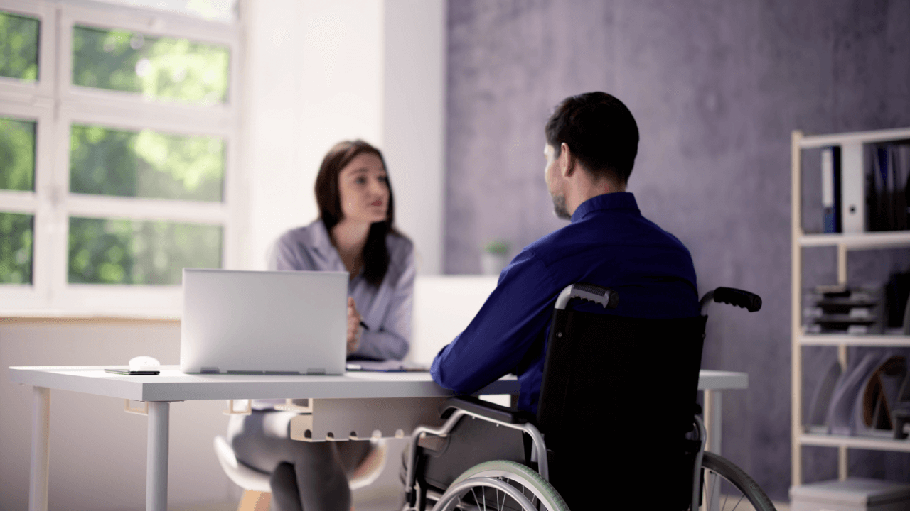 SSDI processing times and backlogs consultation with disability applicant in wheelchair meeting with representative