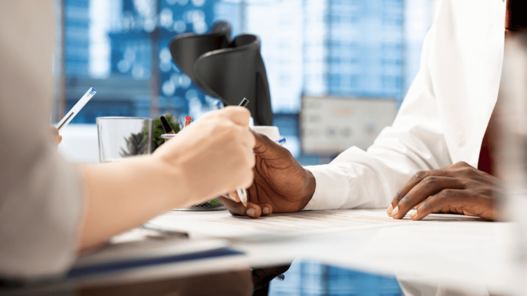 Two people reviewing a CDR short form document during a disability consultation meeting