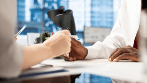 Two people reviewing a CDR short form document during a disability consultation meeting