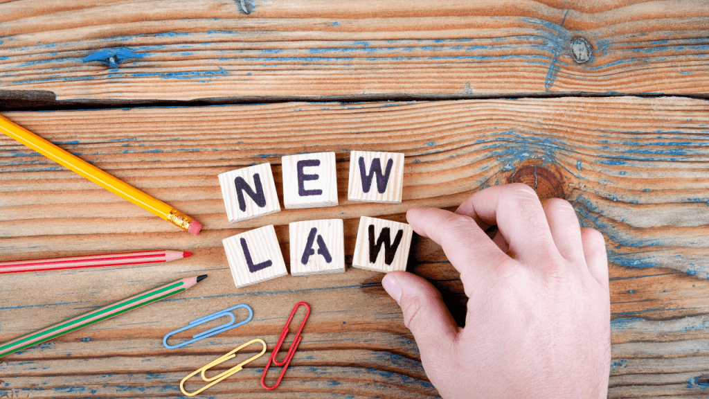 Will SSDI rules change next year illustrated by new law letter blocks on wooden desk with pencils