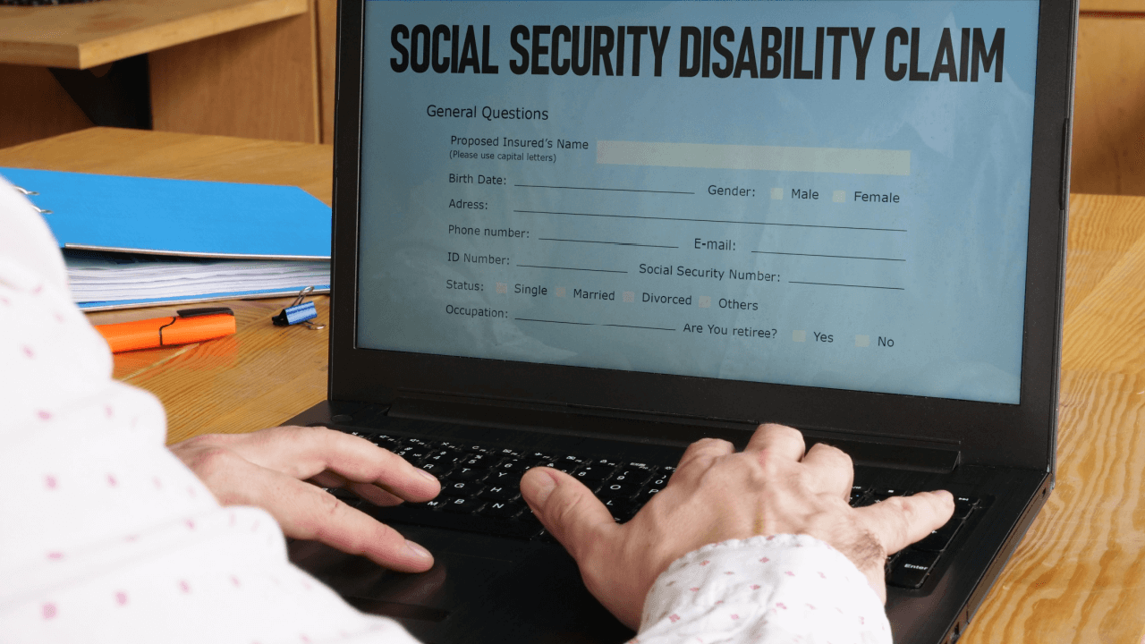 Person completing Social Security Disability claim form wondering why SSDI claims take so long to process