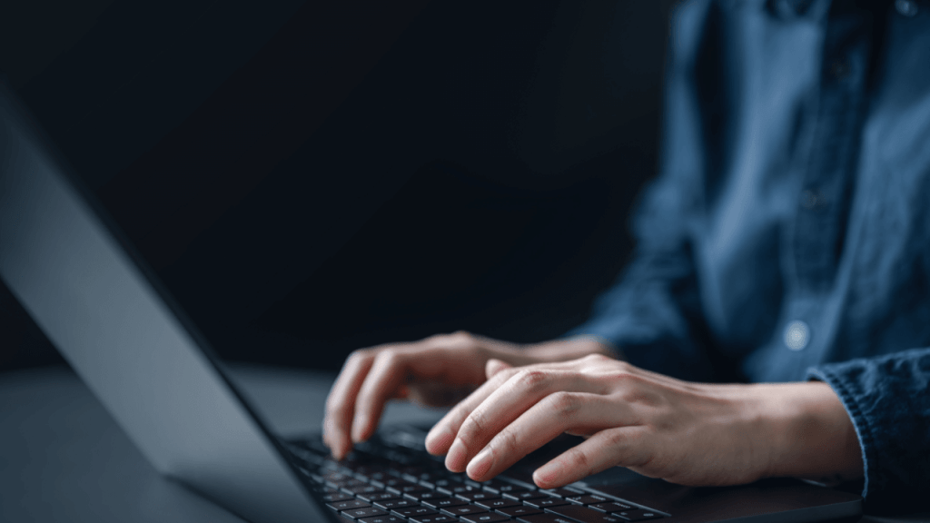 Person typing on laptop researching how long does a continuing disability review take