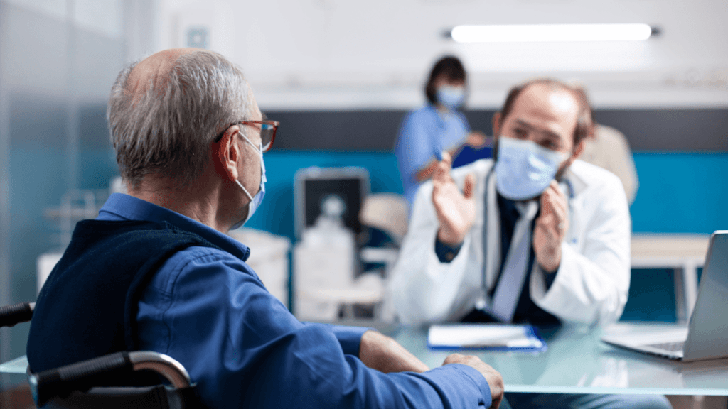Elderly wheelchair user consulting with a doctor during a medical appointment related to how often disability is reevaluated by the SSA