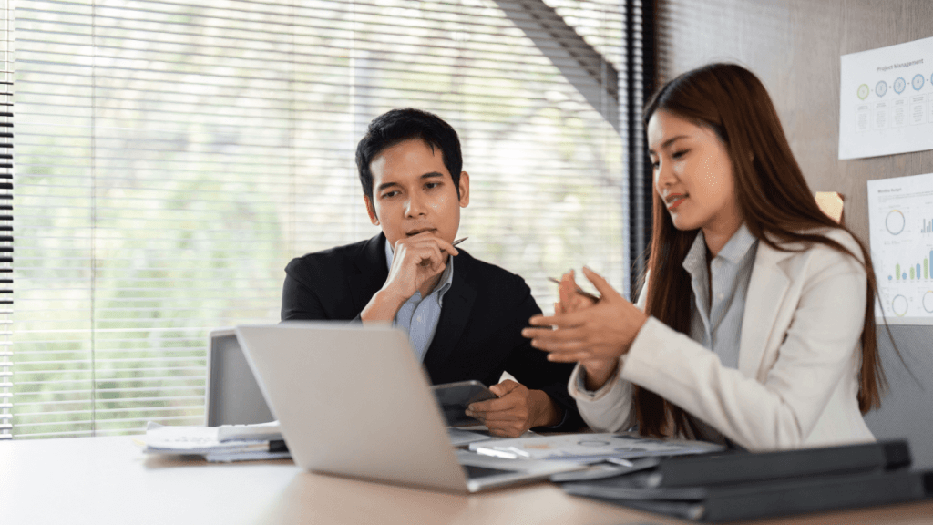 Disability attorney and client discussing SSDI continuing disability review case in office meeting