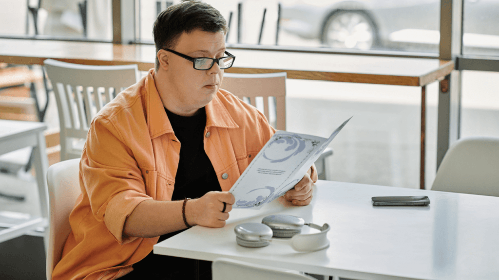Person with Down syndrome reading SSDI documents to understand what is the 5 year rule for disability