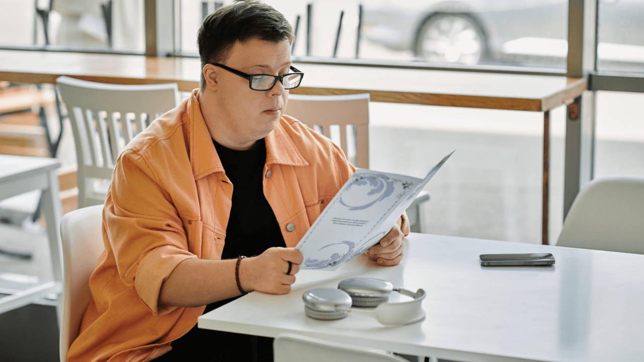Person with Down syndrome reading SSDI documents to understand what is the 5 year rule for disability